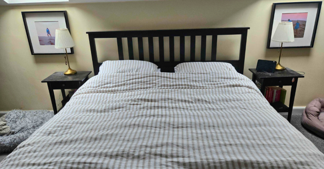 A top view of the Secret Linen Store French Ticking Stripe Natural bedding set on our tester's bed