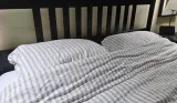 The Secret Linen Store French Ticking Stripe Natural bedding set atop tester Rebecca's bed
