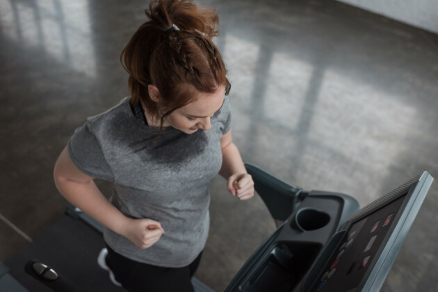 A woman runs on the treadmill