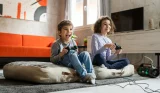 Children playing at home on a playstation