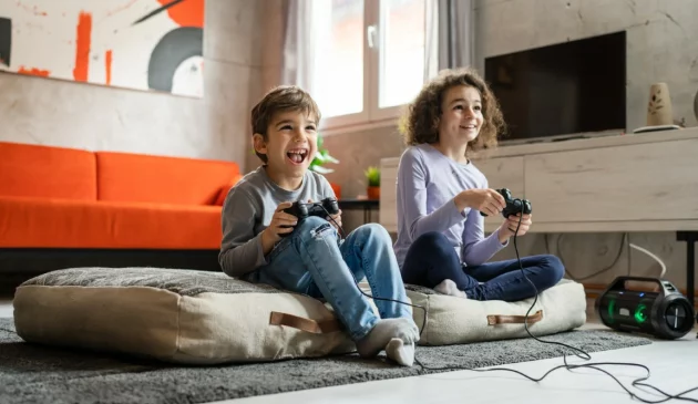Children playing at home on a playstation