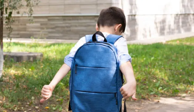 A child with school refusal walking away