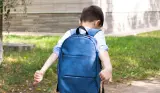 A child with school refusal walking away