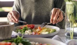 A woman eats a high protein meal