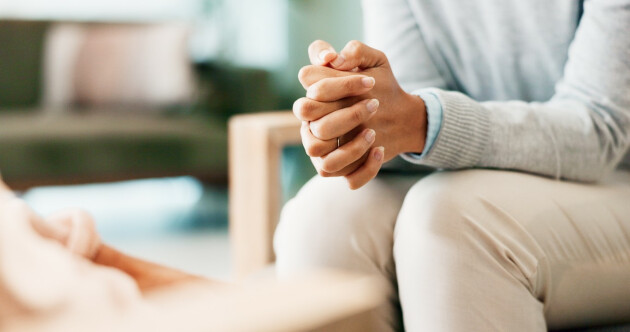 A woman speaks to her GP at a doctors office, close up of her hands