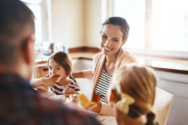 A woman eating a meal with her family