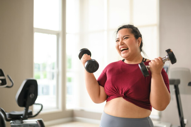 A woman exercises with light weights