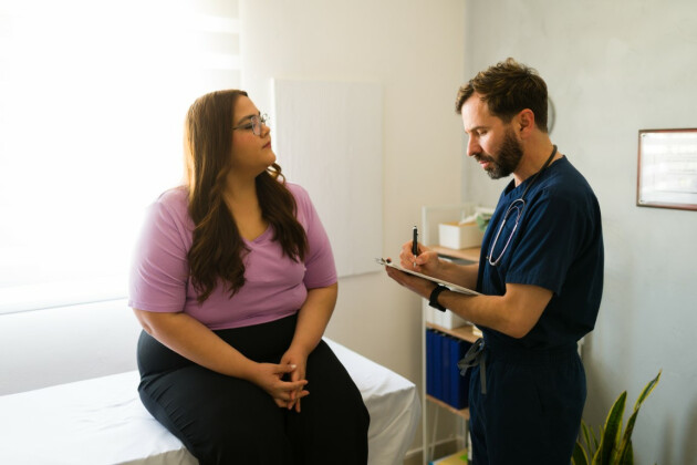 A woman speaks to a male doctor