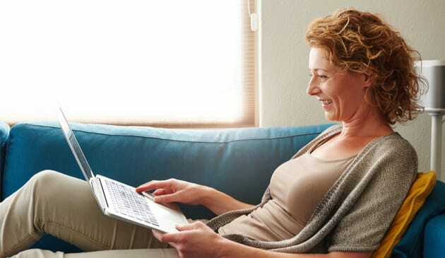 Woman working on sofa