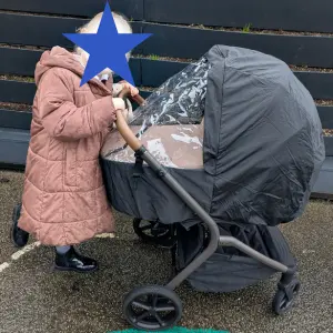 Child pushing Silver Cross Breez