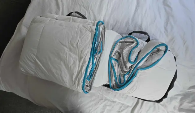 The Simba Hybrid 3-in-1 Duvet still in its carry bag open on a bed