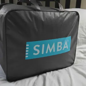 A shot of the Simba Hybrid 3-in-1 Duvet still in its packaging atop a bed