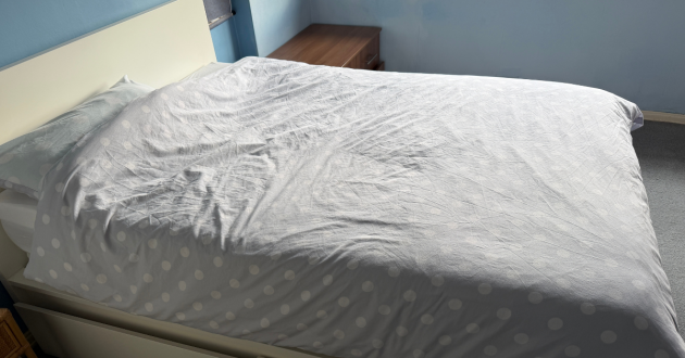 Simba Hybrid Essential Mattress fully made with grey polka dot bedding in a real bedroom
