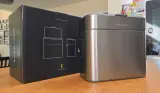 The simplehuman Compost Caddy on top of a kitchen counter next to its packaging box