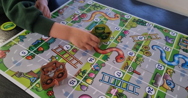 Child playing My First Snakes & Ladders