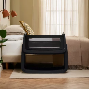 SnuzPod5 crib in black next to bed