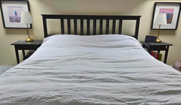 The Soak & Sleep White French Linen bedding shown on a tester's bed in a real world setting