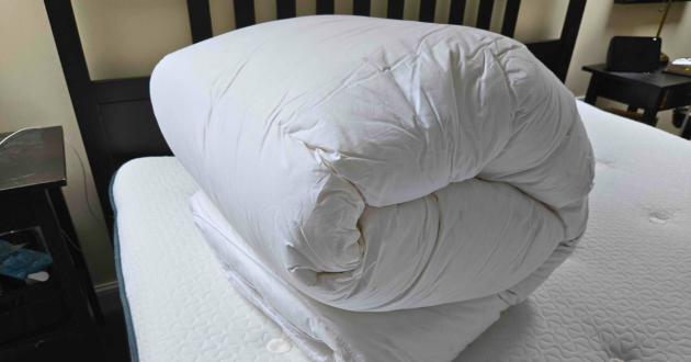 The Soak & Sleep mattress topper rolled up