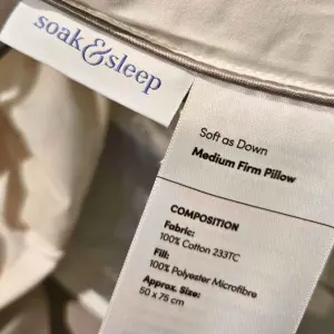 A close up of the Soak & Sleep soft as down pillow label