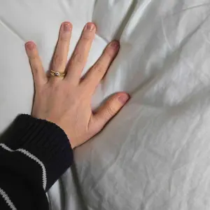 A hand shows how plush the Soak & Sleep Soft as Down pillow really is