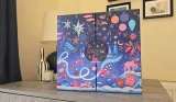 Closed Space NK 2026 Beauty Advent Calendar on a cupboard, with a navy cover decorated in colourful festive illustrations