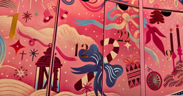 Close-up of pink calendar drawers decorated with a candy cane, bow and gold numbers 12 and 22