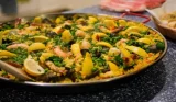 traditional Spanish paella dish served in a large paella pan