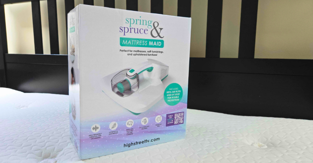 The Spring & Spruce Mattress Maid mattress cleaner in its box atop a super king mattress