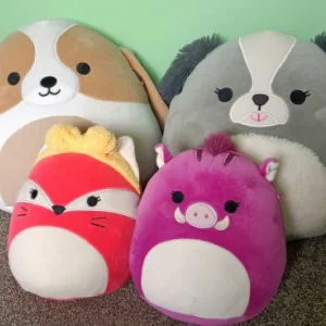 Two Squishmallow dogs, a fox and a warthog