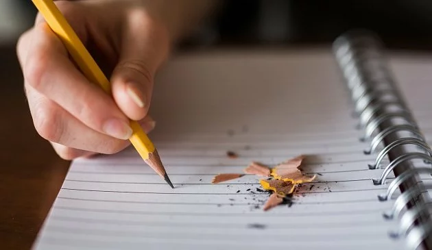 girl writing in notebook