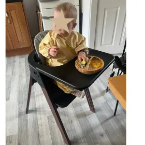 Baby sitting in Stokke Steps highchair