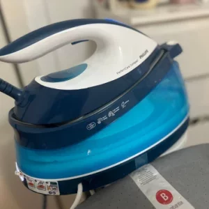 a Philips PerfectCare Compact Steam Generator Iron on an ironing board