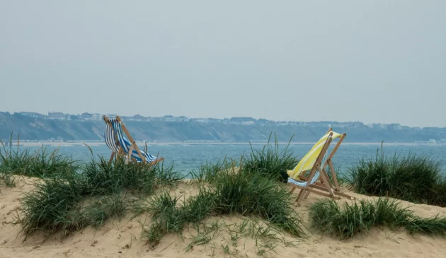 Two deckchairs on a sand dune