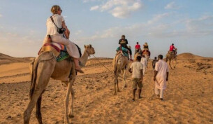 A family on a camel trek on A Take the Family break