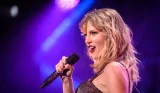 Taylor Swift singing into microphone
