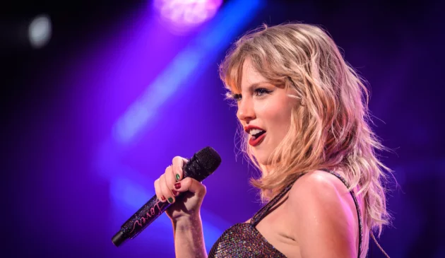 Taylor Swift singing into microphone