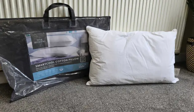 The Fine Bedding Company SmartCool Cotton Pillow next to its packaging