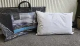 The Fine Bedding Company SmartCool Cotton Pillow next to its packaging