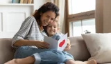 Woman looking at card with child