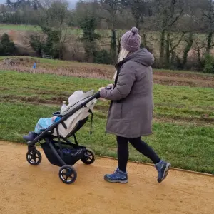 Mum pushing child in Thule Spring 2 stroller
