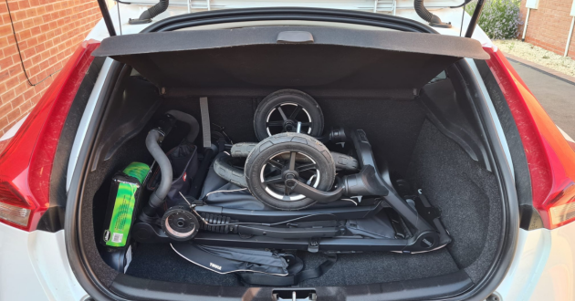 Thule Urban Glide 4-Wheel buggy folded in the boot of a Volvo V40