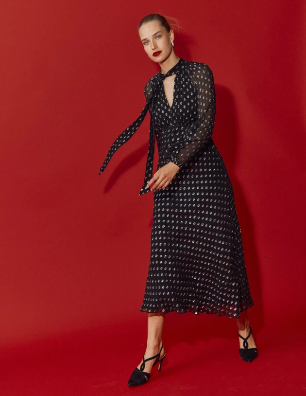 A model wears Boden's Tie Neck Midi Dress