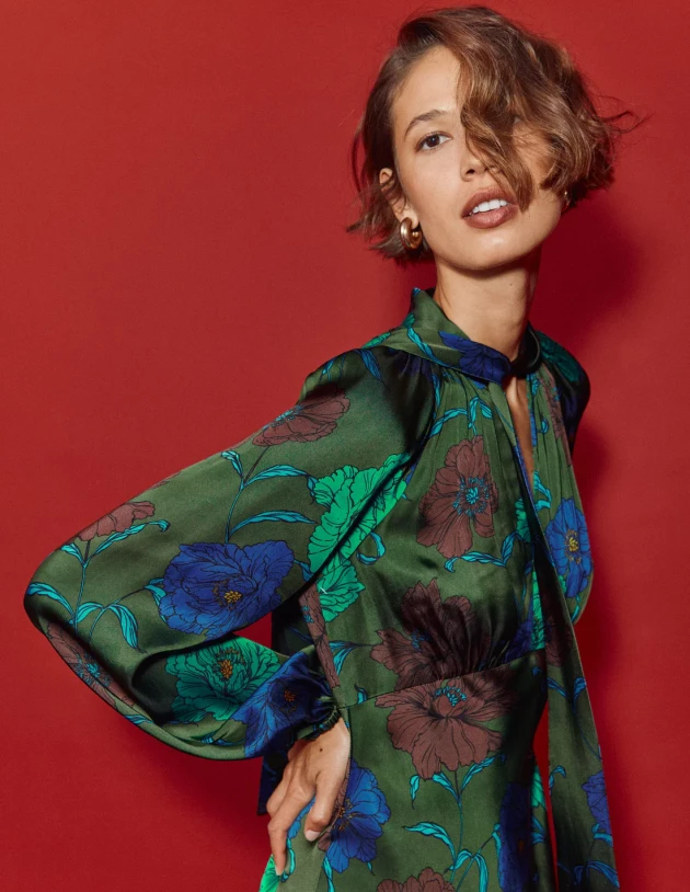 A model wears Boden's Tie Neck Satin Midi Dress