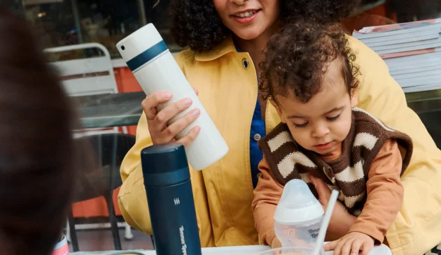 Mother with child on lap and Tommee Tippee PrepGo in hand