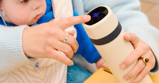 Mother with child on lap using Tommee Tippee PrepGo