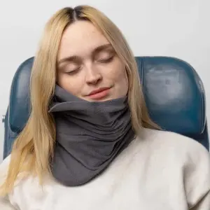 Trtl Travel Pillow being used by a woman asleep