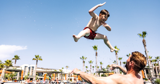 A dad and son in a swimming pool on a TUI family holiday