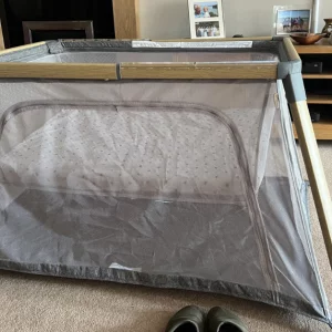Tutti Bambini Cozee go travel cot review image of travel cot in a living room