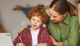 Woman and child doing home learning together