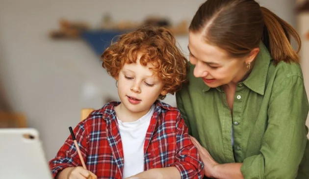 Woman and child doing home learning together